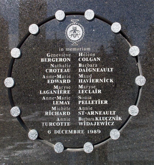 a marble and stone plaque with the names of the 14 women murdered on 6 December 1989 carved on it, surrounded by a circle with 14 smaller circles representing each of the women